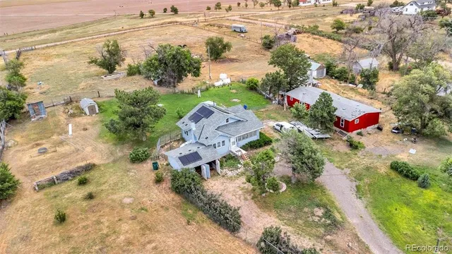 an aerial view of a house with a yard and lake view