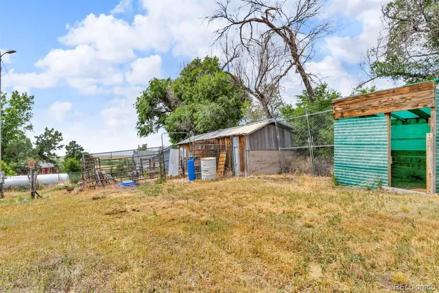 a front view of house with yard and trees in the background