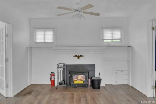 a view of a livingroom with a fireplace and window