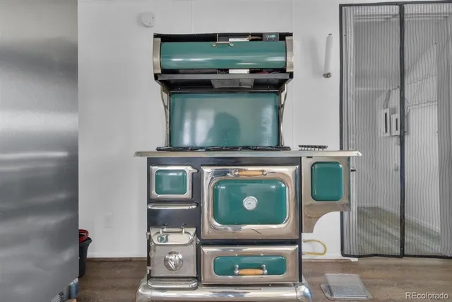 a stove top oven sitting inside of a kitchen