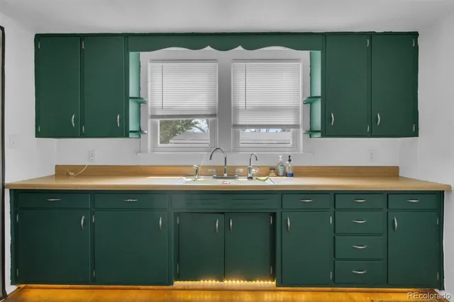 a bathroom with a sink and a large window