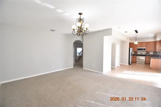 a view of a kitchen with refrigerator and cabinets