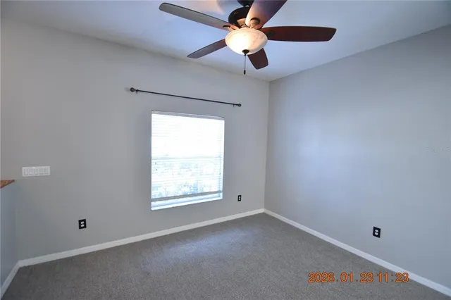 a view of a small space with a chandelier fan