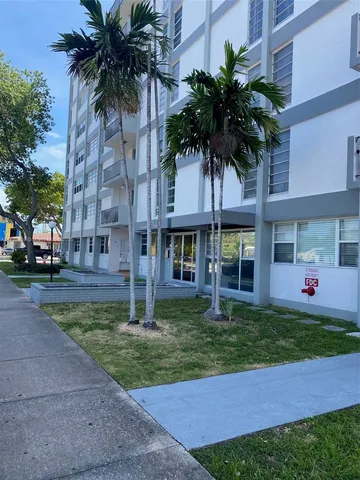 a front view of a house with garden and porch