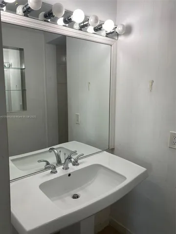 a white toilet sitting next to a shower