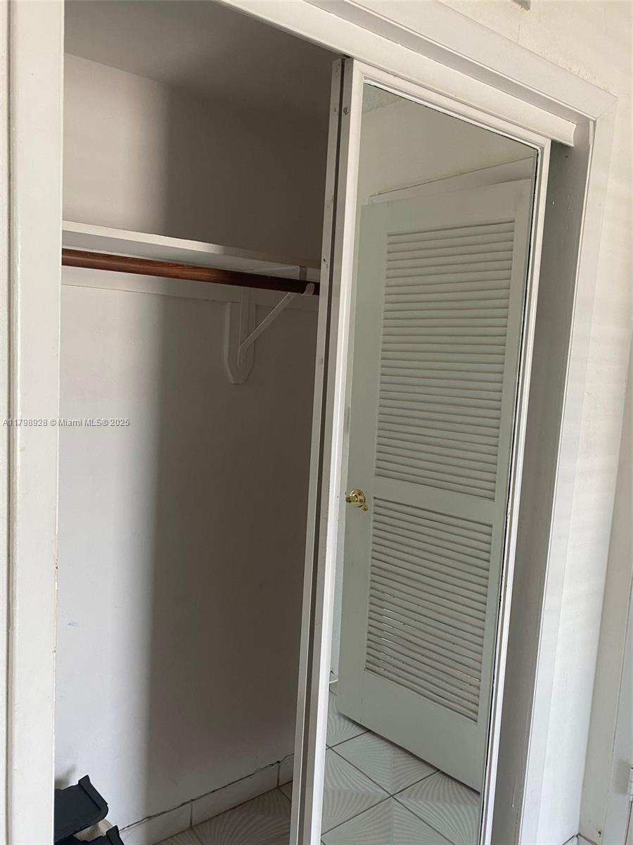 1400 Southwest 27th Avenue, Unit 202 Miami, FL 33145 - Photo 25 of 34 a bathroom with a glass shower door