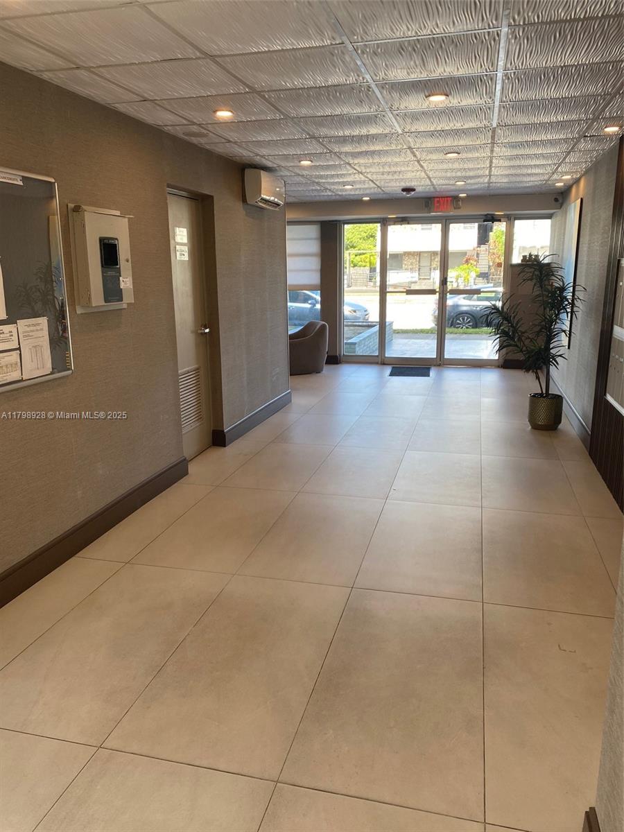1400 Southwest 27th Avenue, Unit 202 Miami, FL 33145 - Photo 6 of 34 a view of a hallway with wooden floor