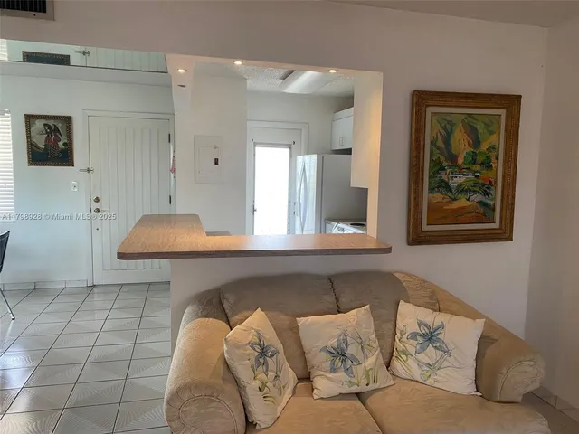 a living room with furniture and a wall painting