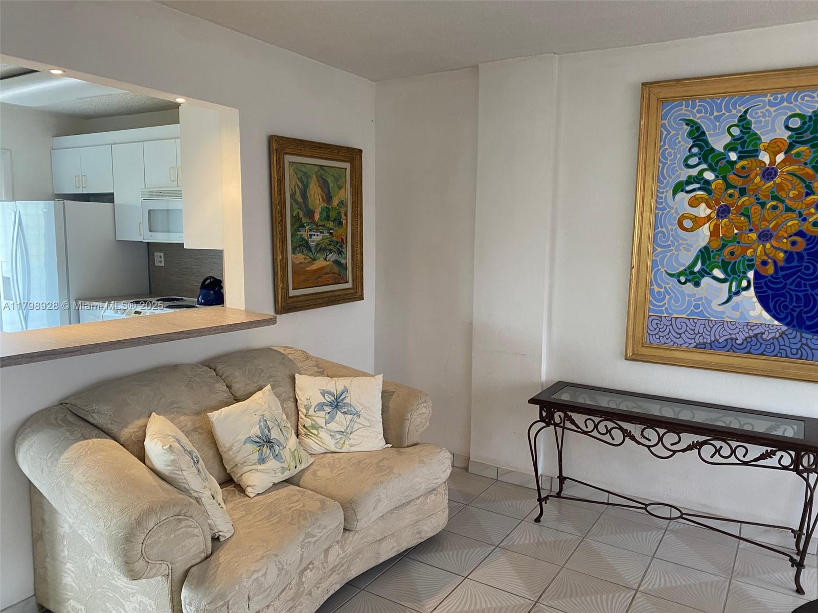 1400 Southwest 27th Avenue, Unit 202 Miami, FL 33145 - Photo 8 of 34 a living room with furniture and a wall painting