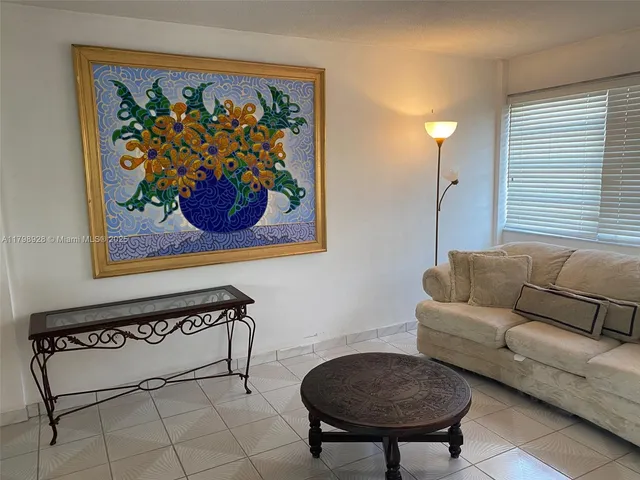a view of a livingroom with furniture and a window
