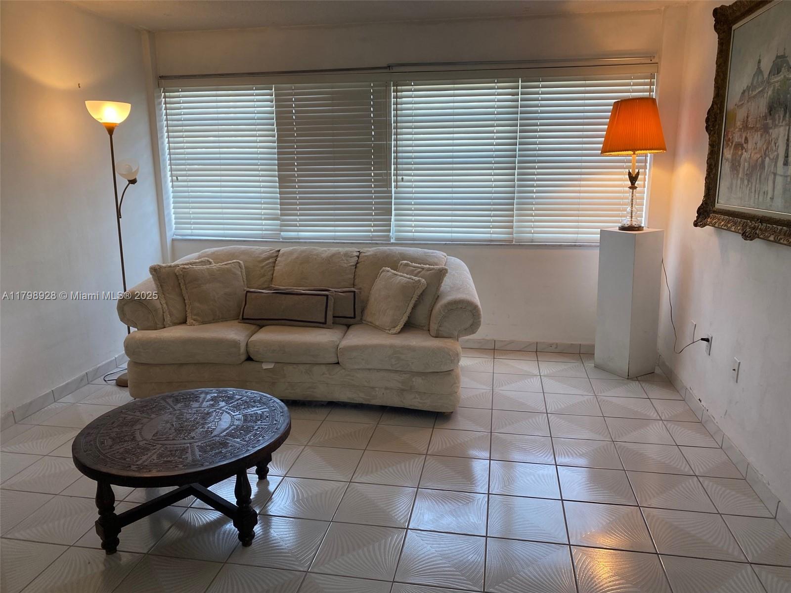 1400 Southwest 27th Avenue, Unit 202 Miami, FL 33145 - Photo 10 of 34 a view of a livingroom with furniture and a window
