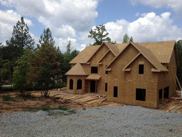0 Elys Ridge Newnan, GA 30263 - Photo 1 of 1 a front view of a house with a yard and garage