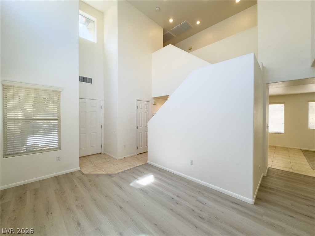 9456 Grandview Spring Avenue Las Vegas, NV 89166 - Photo 5 of 49 The bright interior features tall ceilings, diverse flooring, and architectural design elements.