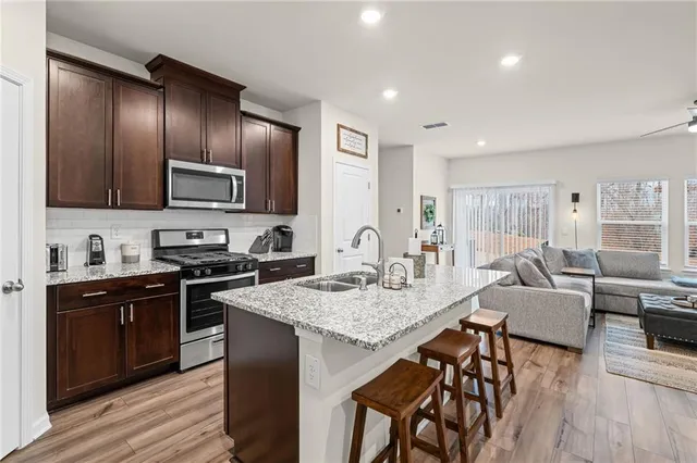 a kitchen with granite countertop stainless steel appliances and wooden cabinets
