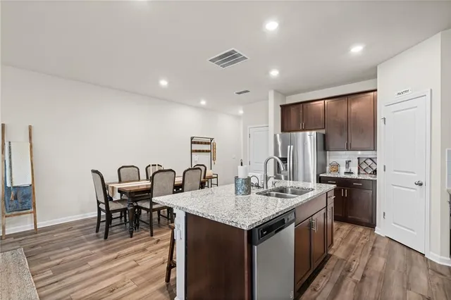 a kitchen with kitchen island granite countertop a sink stove and refrigerator
