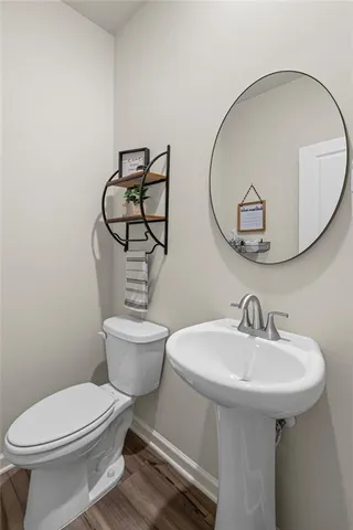 a bathroom with a toilet a sink and a mirror