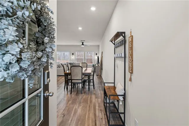 a dining room with furniture and wooden floor