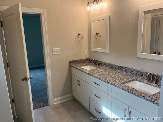 112 Surles Road Benson, NC 27504 - Photo 15 of 40 a bathroom with a granite countertop sink and a mirror