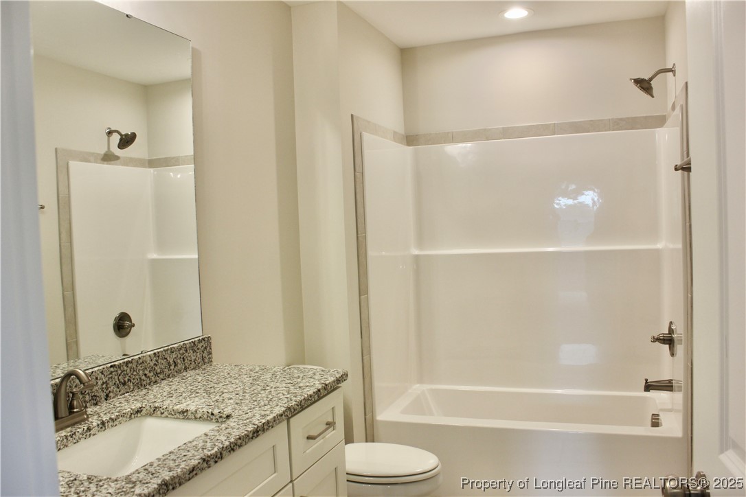 112 Surles Road Benson, NC 27504 - Photo 24 of 40 a bathroom with a granite countertop sink toilet and shower