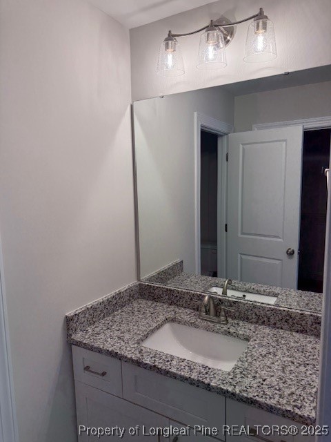 112 Surles Road Benson, NC 27504 - Photo 28 of 40 a bathroom with a granite countertop sink and a mirror
