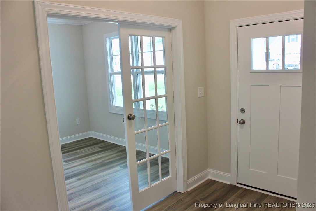 112 Surles Road Benson, NC 27504 - Photo 4 of 40 a view of an empty room with wooden floor and a window