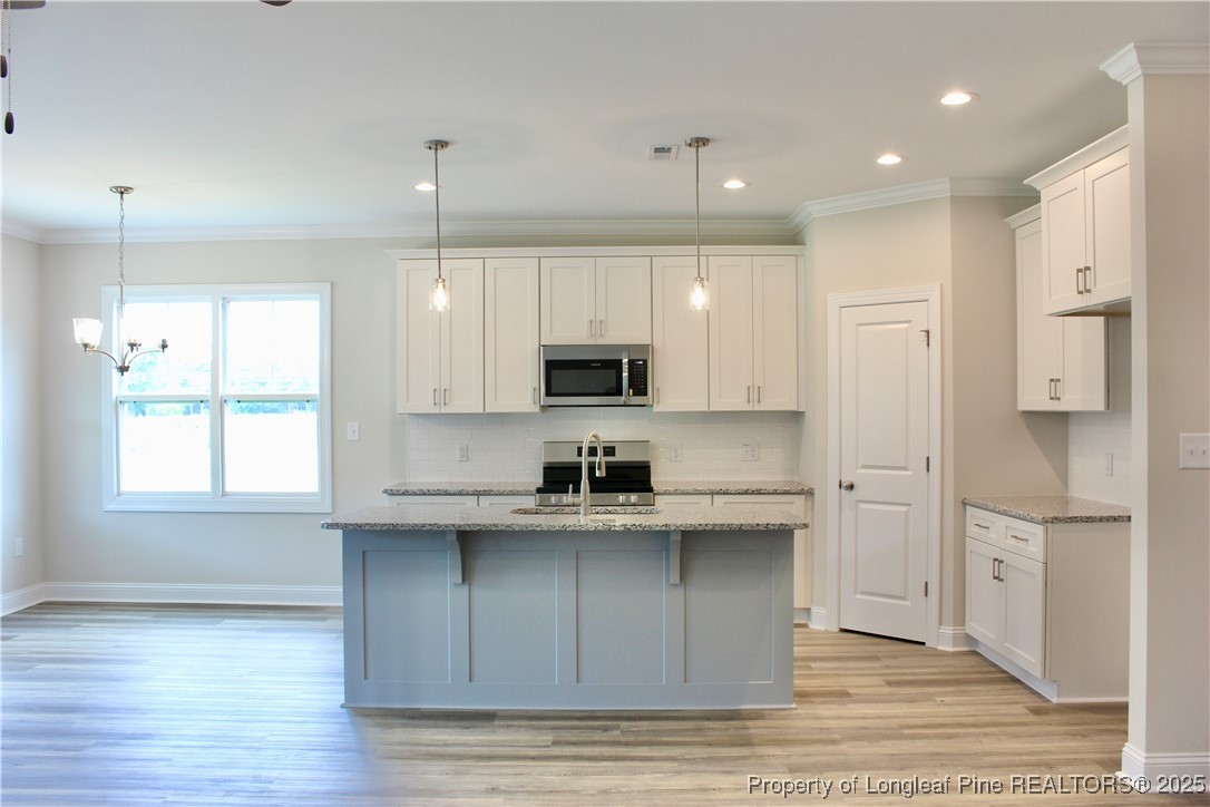 112 Surles Road Benson, NC 27504 - Photo 8 of 40 a kitchen with stainless steel appliances granite countertop a refrigerator and a sink