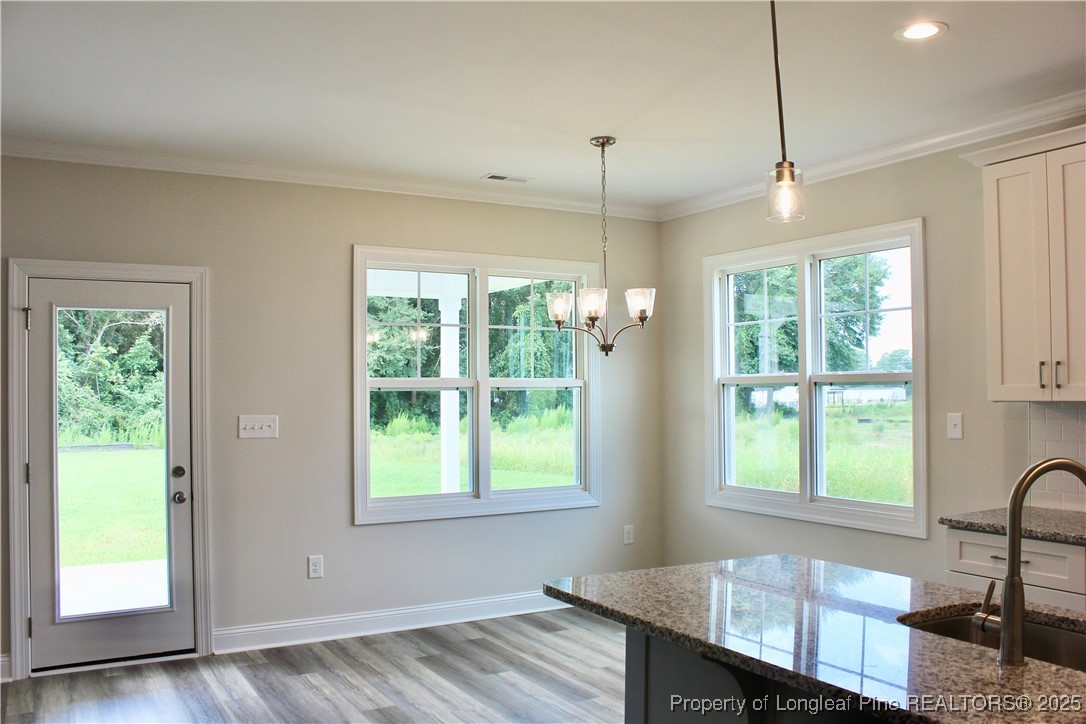 112 Surles Road Benson, NC 27504 - Photo 10 of 40 a view of a room with furniture window and wooden floor