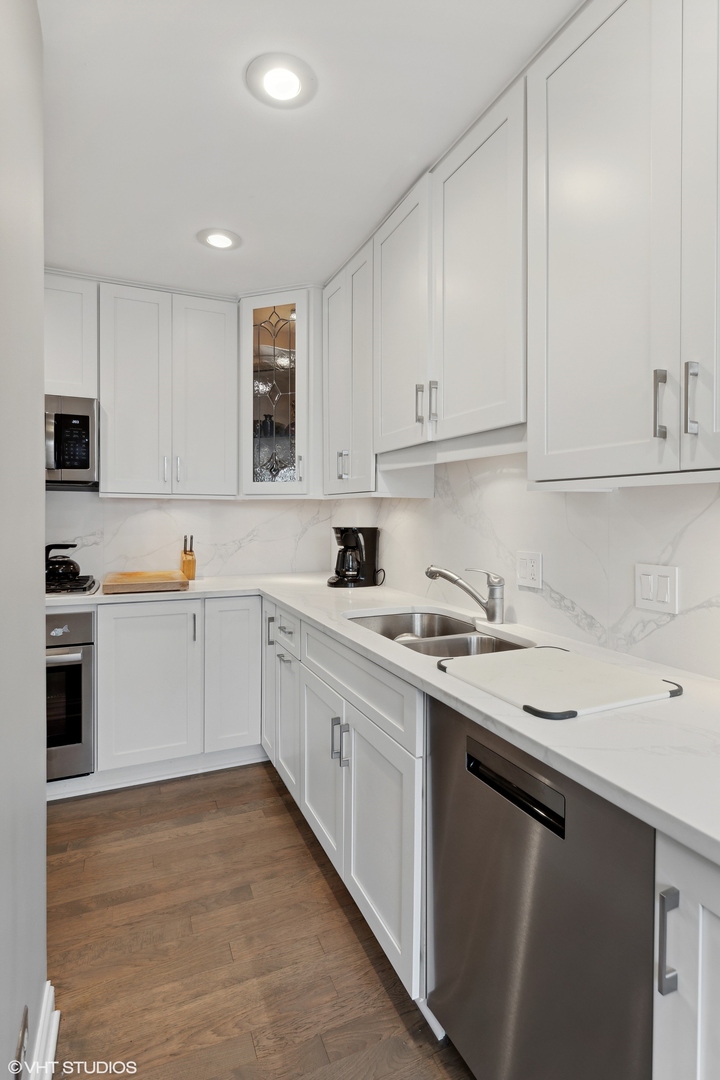 3305 North Racine Avenue, Unit E Chicago, IL 60657 - Photo 11 of 30 a kitchen with a sink stove and cabinets
