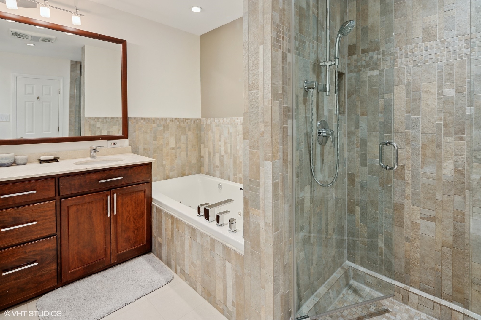 3305 North Racine Avenue, Unit E Chicago, IL 60657 - Photo 18 of 30 a bathroom with a bathtub a sink a vanity and a shower