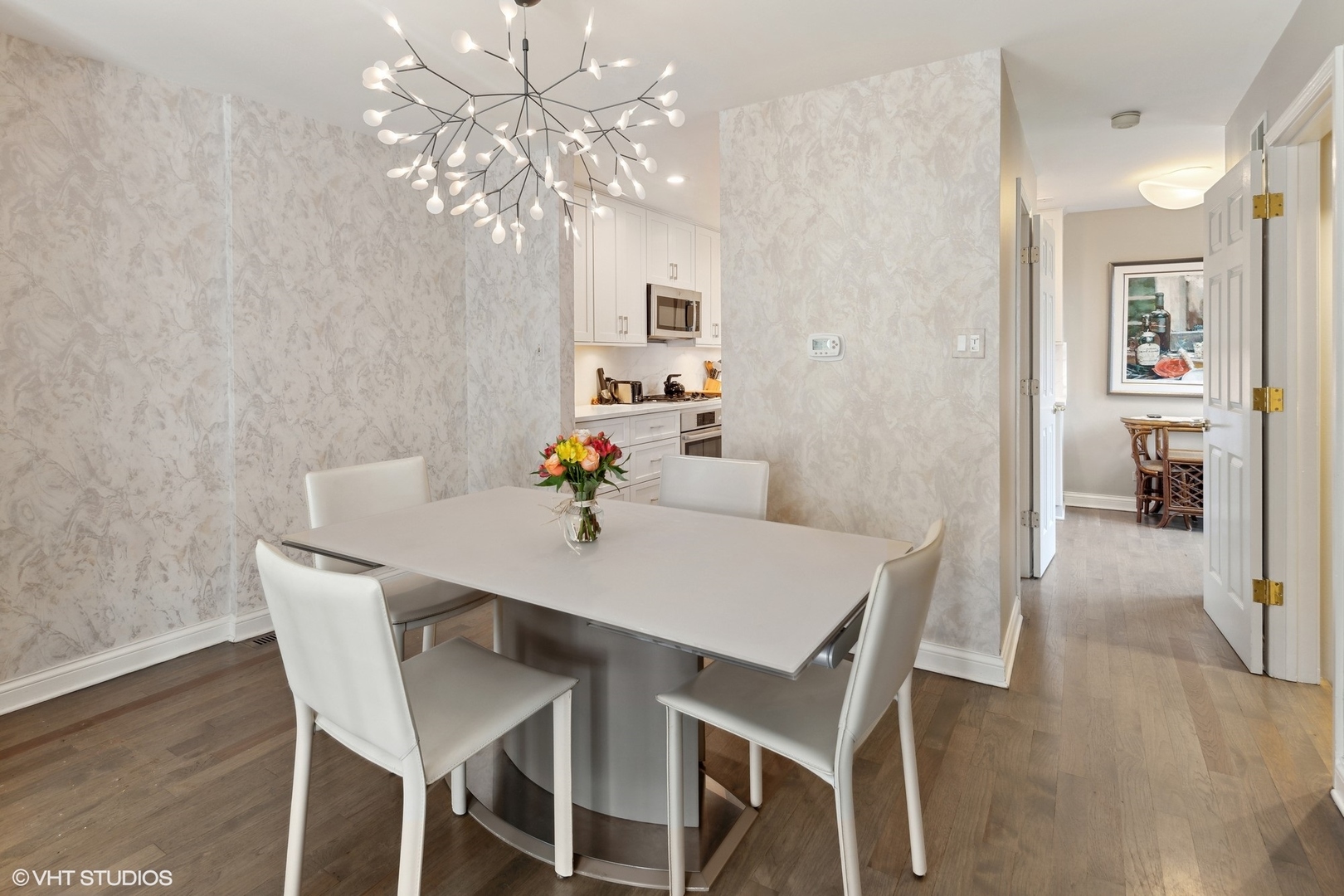 3305 North Racine Avenue, Unit E Chicago, IL 60657 - Photo 7 of 30 a view of a dining room with furniture and chandelier