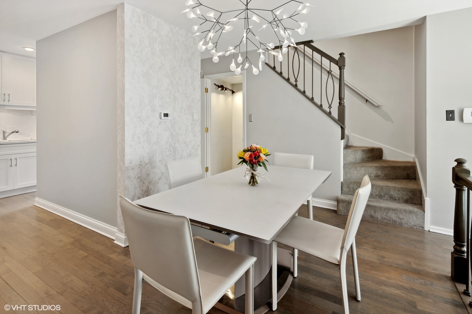 3305 North Racine Avenue, Unit E Chicago, IL 60657 - Photo 8 of 30 a view of a dining room with furniture and wooden floor