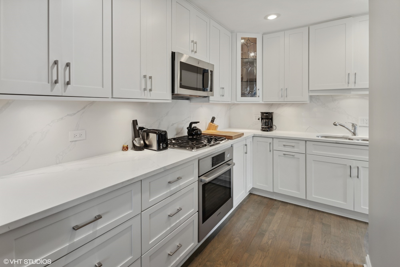 3305 North Racine Avenue, Unit E Chicago, IL 60657 - Photo 9 of 30 a kitchen with white cabinets and white appliances