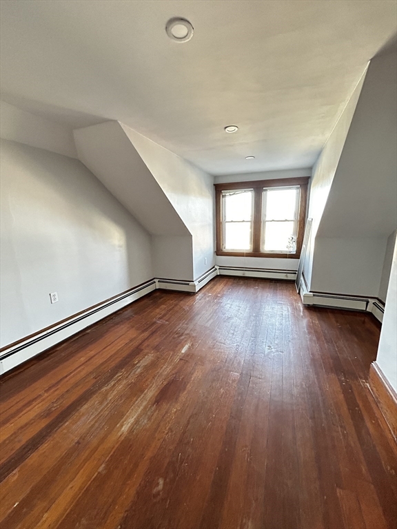 19 Roslyn Street, Unit 2 Salem, MA 01970 - Photo 15 of 17 an empty room with wooden floor and windows