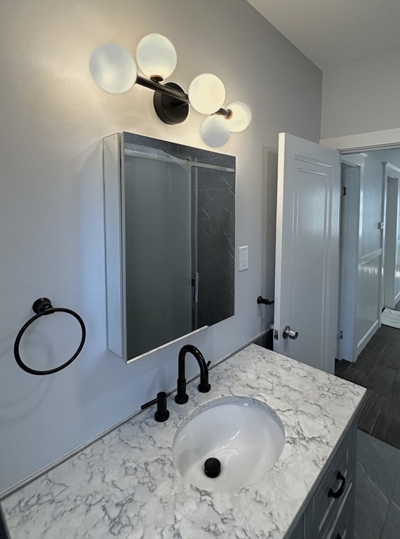 19 Roslyn Street, Unit 2 Salem, MA 01970 - Photo 4 of 17 a bathroom with a granite countertop sink and a mirror