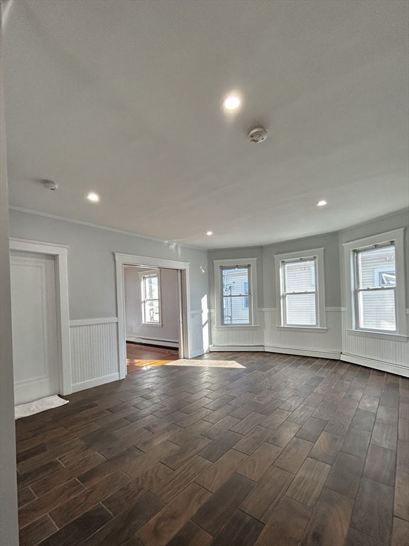 19 Roslyn Street, Unit 2 Salem, MA 01970 - Photo 5 of 17 an empty room with wooden floor and windows
