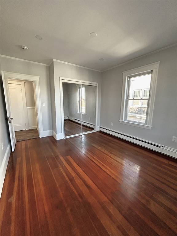 19 Roslyn Street, Unit 2 Salem, MA 01970 - Photo 9 of 17 an empty room with wooden floor and windows