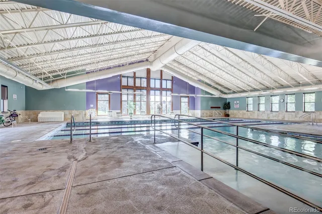 a view of a bench in the garden near a lake