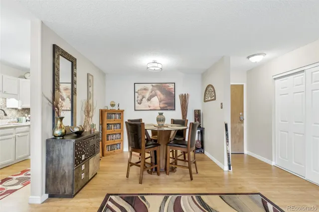 a kitchen with white cabinets sink and stainless steel appliances