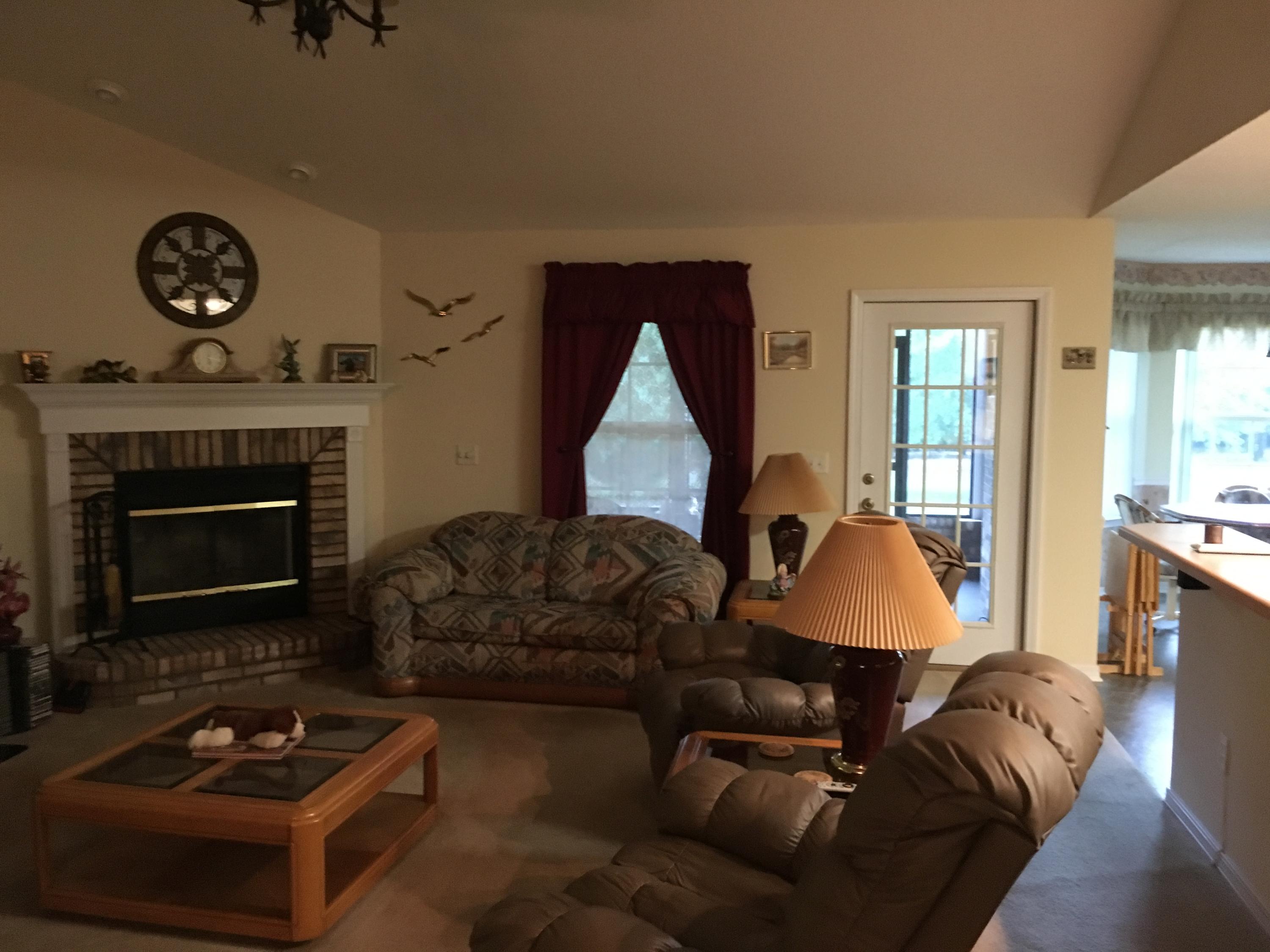 6135 Holloway Road Baker, FL 32531 - Photo 14 of 23 a living room with furniture a fireplace a rug and a large window