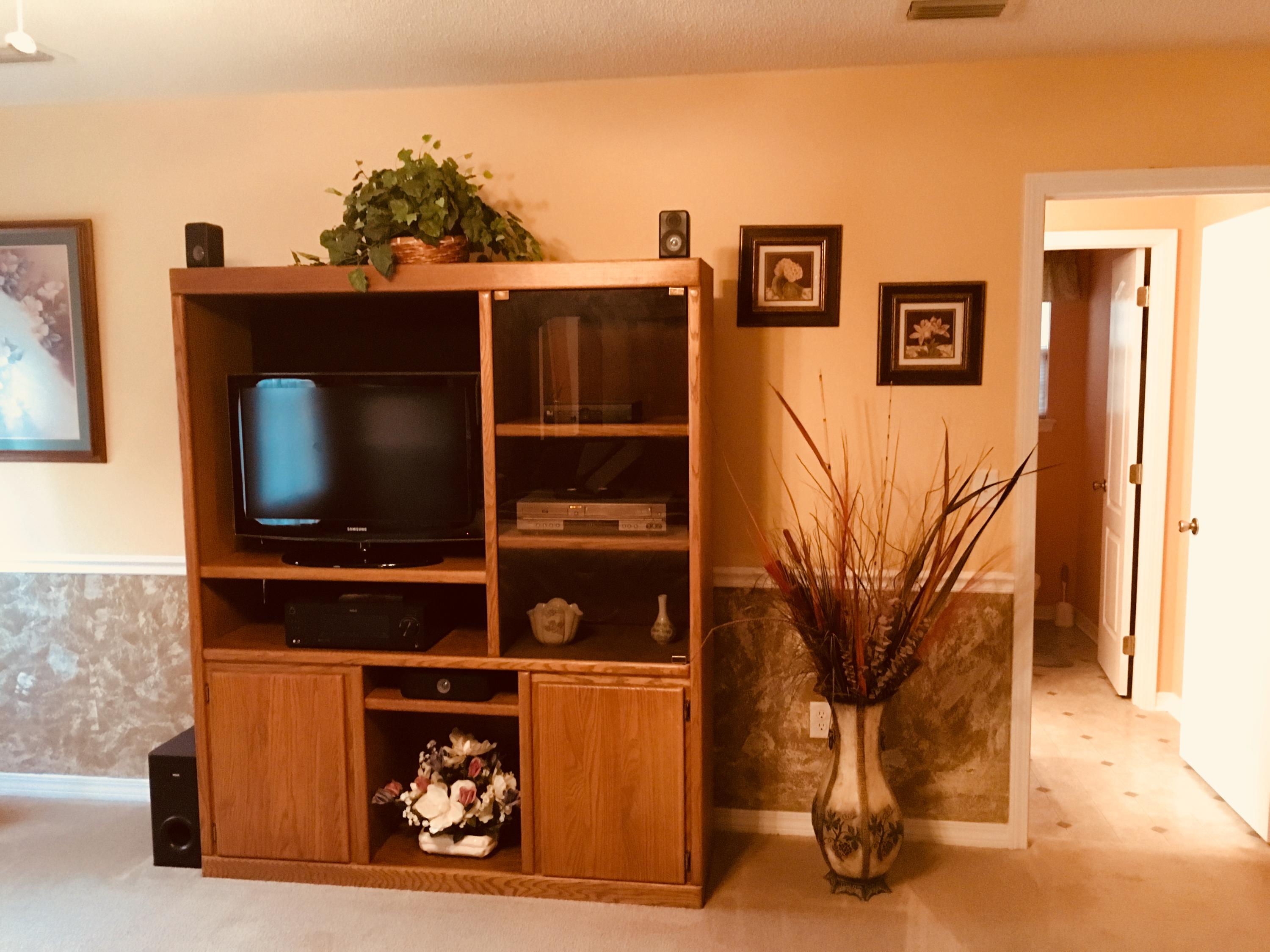 6135 Holloway Road Baker, FL 32531 - Photo 16 of 23 a living room with a flat screen tv and a wall painting