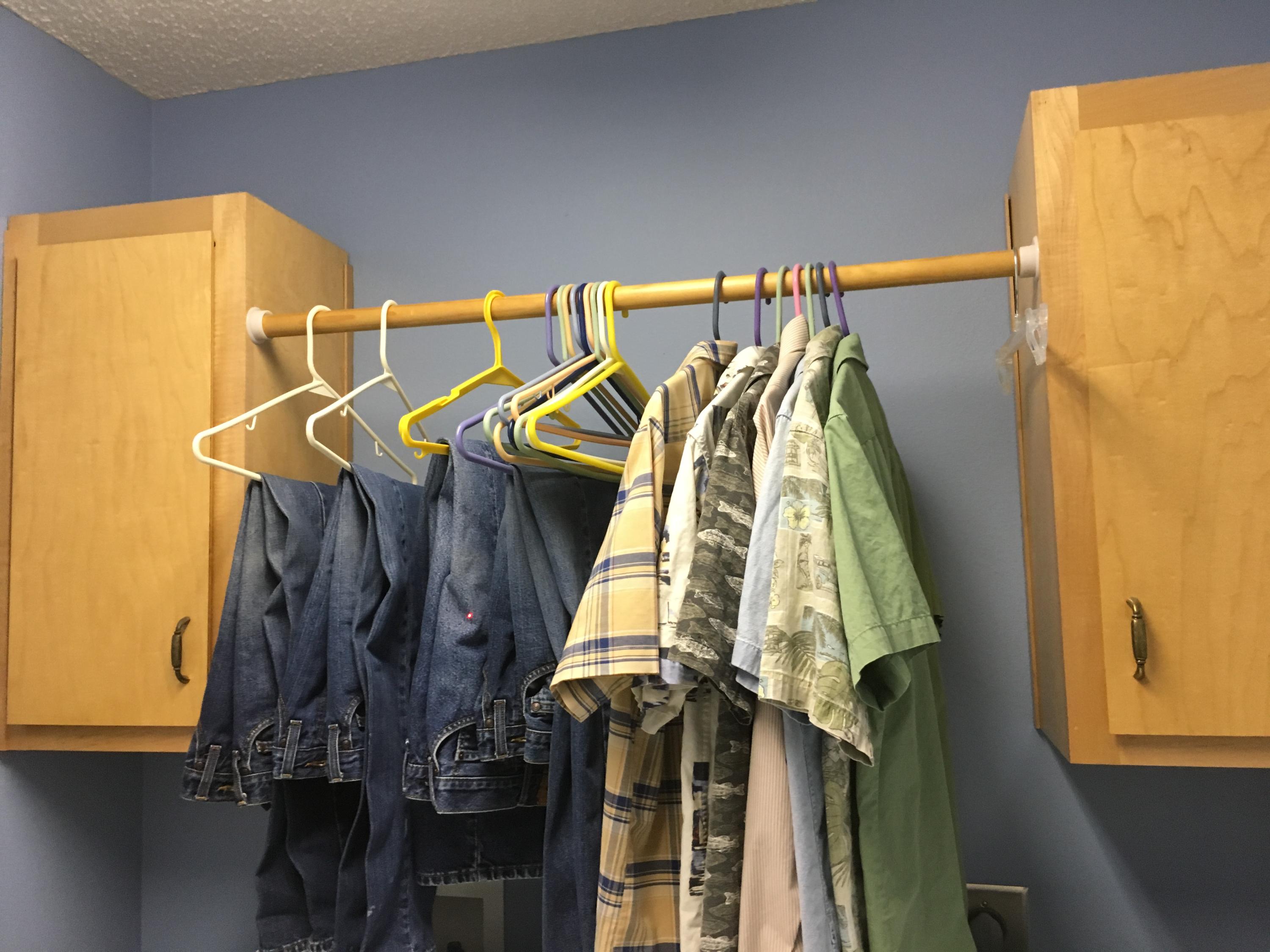 6135 Holloway Road Baker, FL 32531 - Photo 19 of 23 a view of walk in closet with clothes and shoes