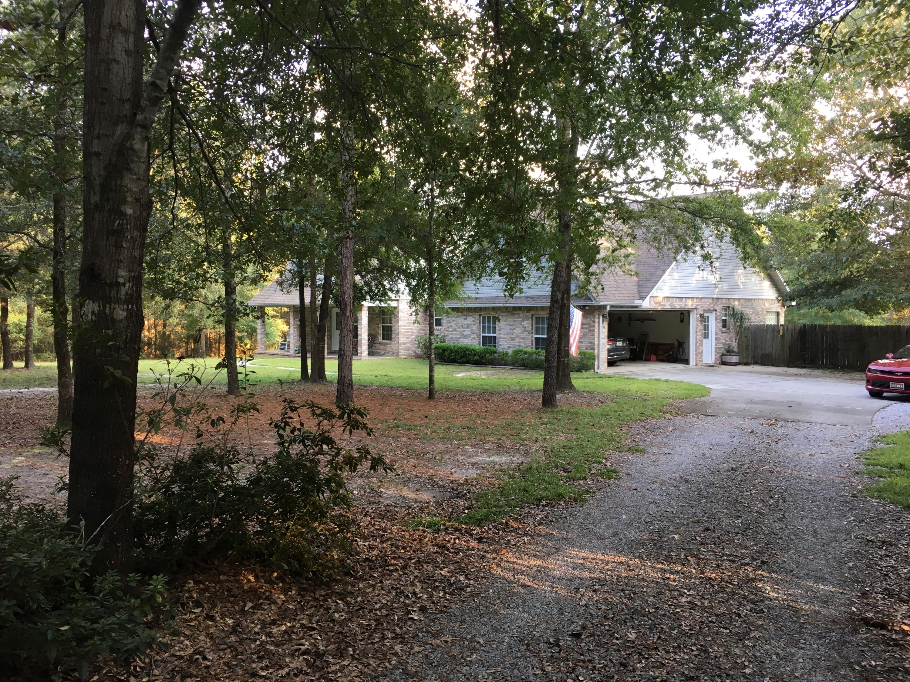 6135 Holloway Road Baker, FL 32531 - Photo 4 of 23 a view of a house with backyard and a tree