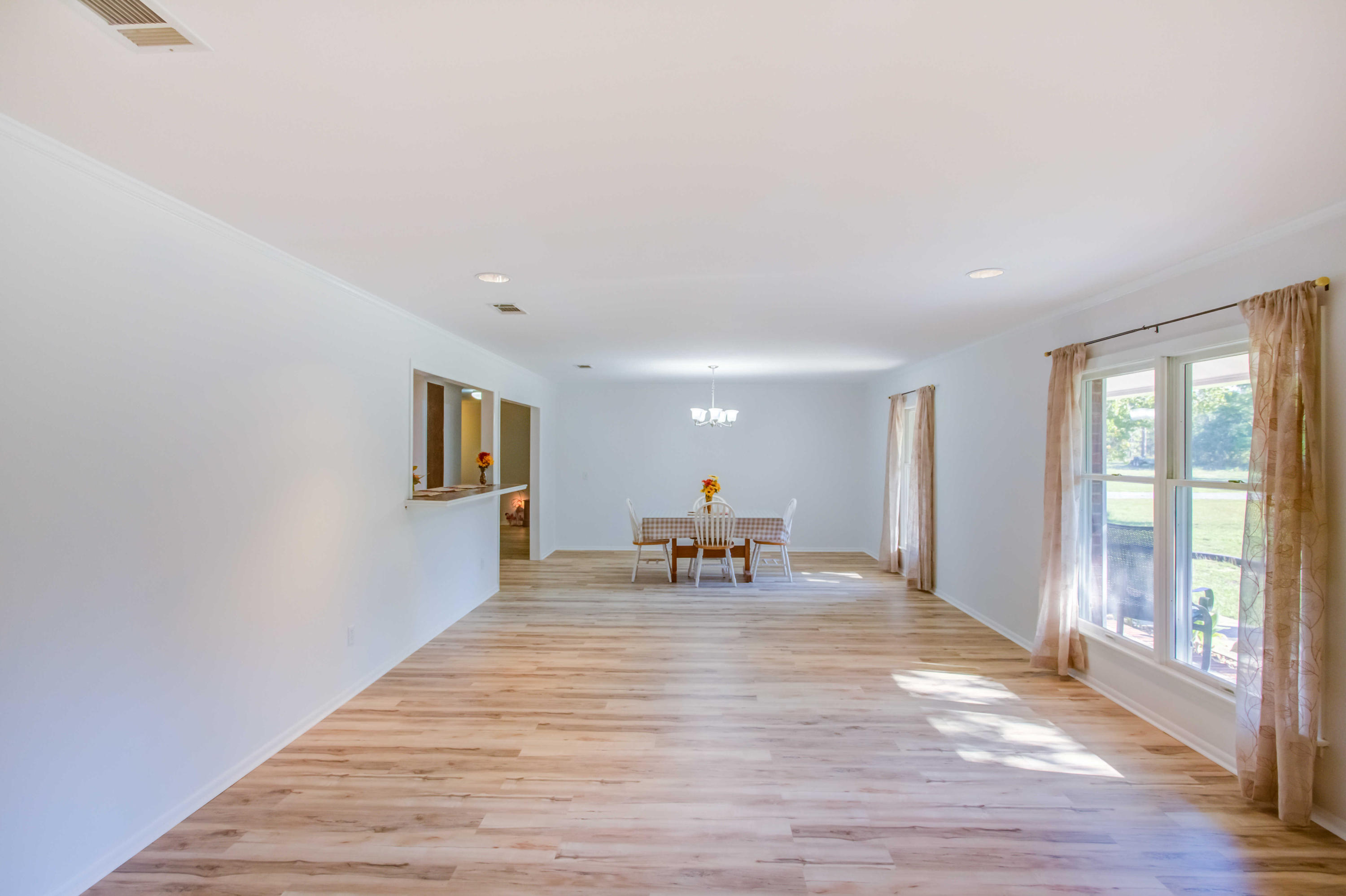 6116 Pine Ridge Lane Crestview, FL 32539 - Photo 11 of 45 a view of a livingroom with wooden floor and a floor to ceiling window
