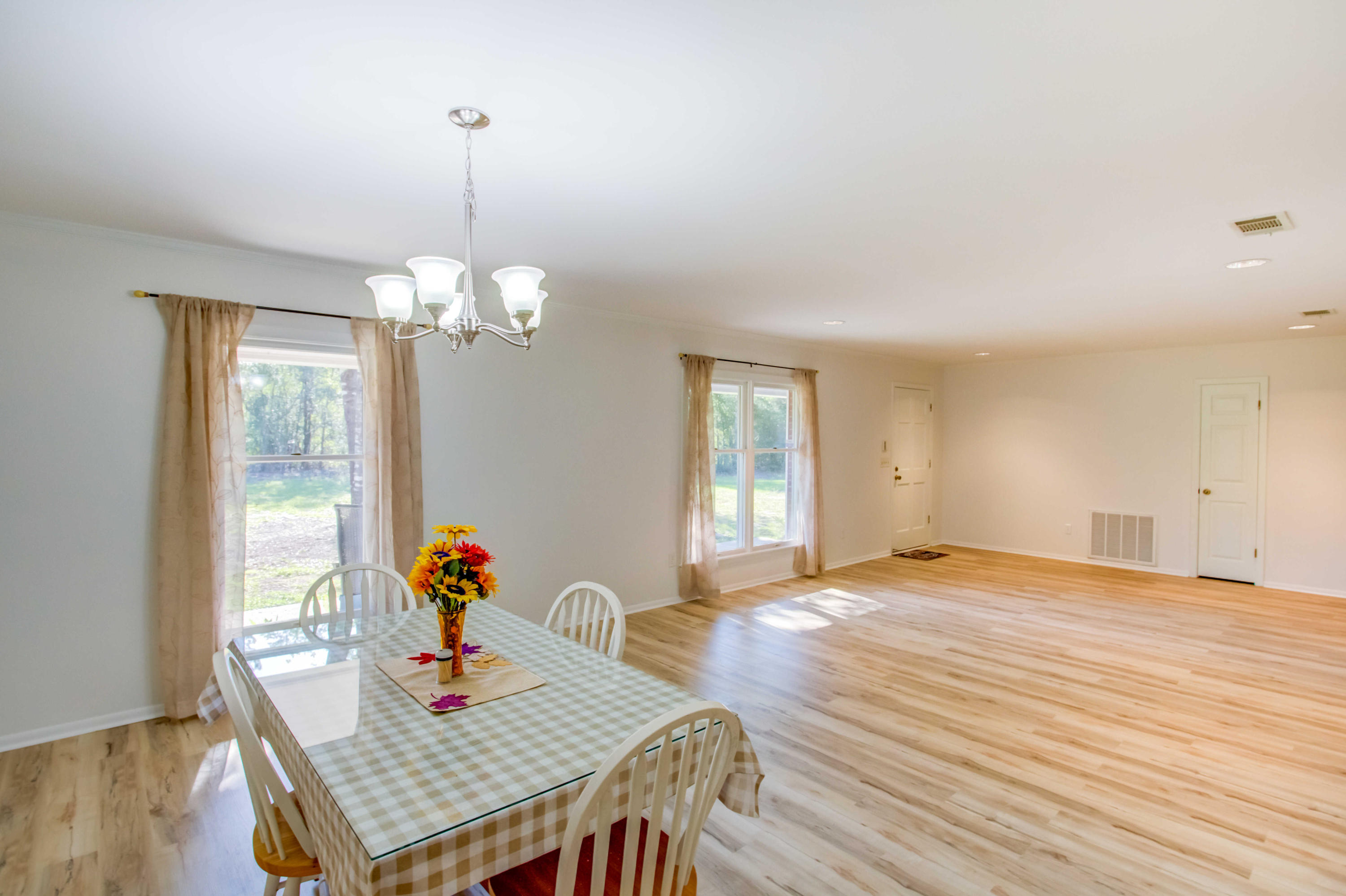 6116 Pine Ridge Lane Crestview, FL 32539 - Photo 12 of 45 a view of a dining room with furniture and wooden floor