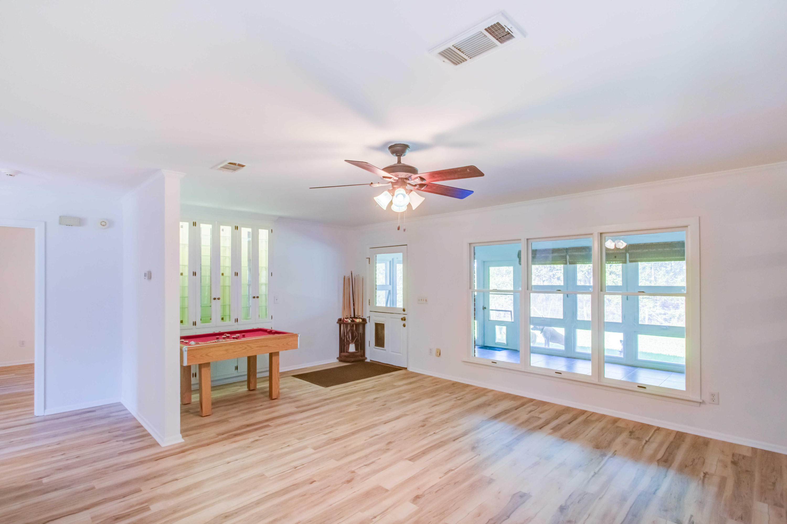 6116 Pine Ridge Lane Crestview, FL 32539 - Photo 14 of 45 a bedroom with a bed and a chandelier