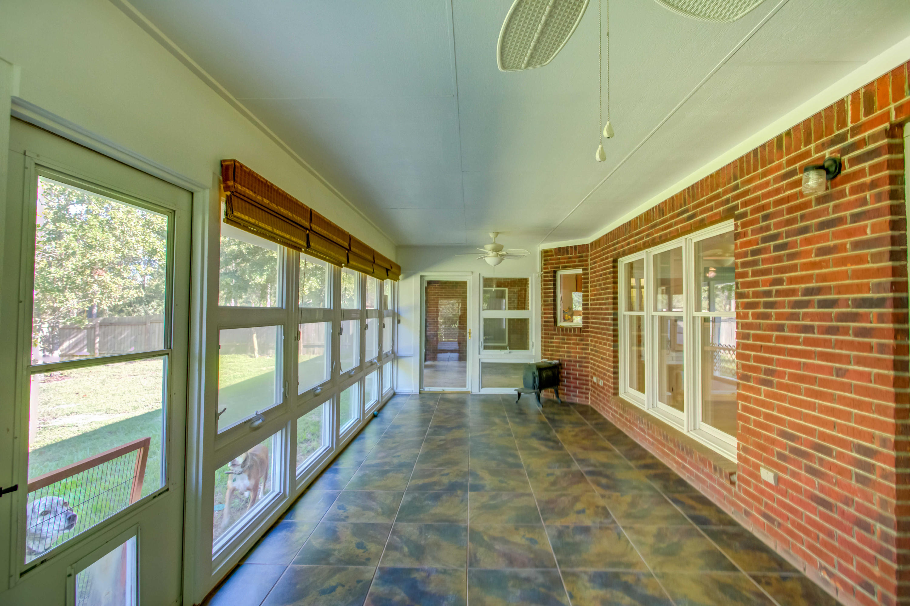 6116 Pine Ridge Lane Crestview, FL 32539 - Photo 16 of 45 a view of a porch with wooden floor and outdoor space