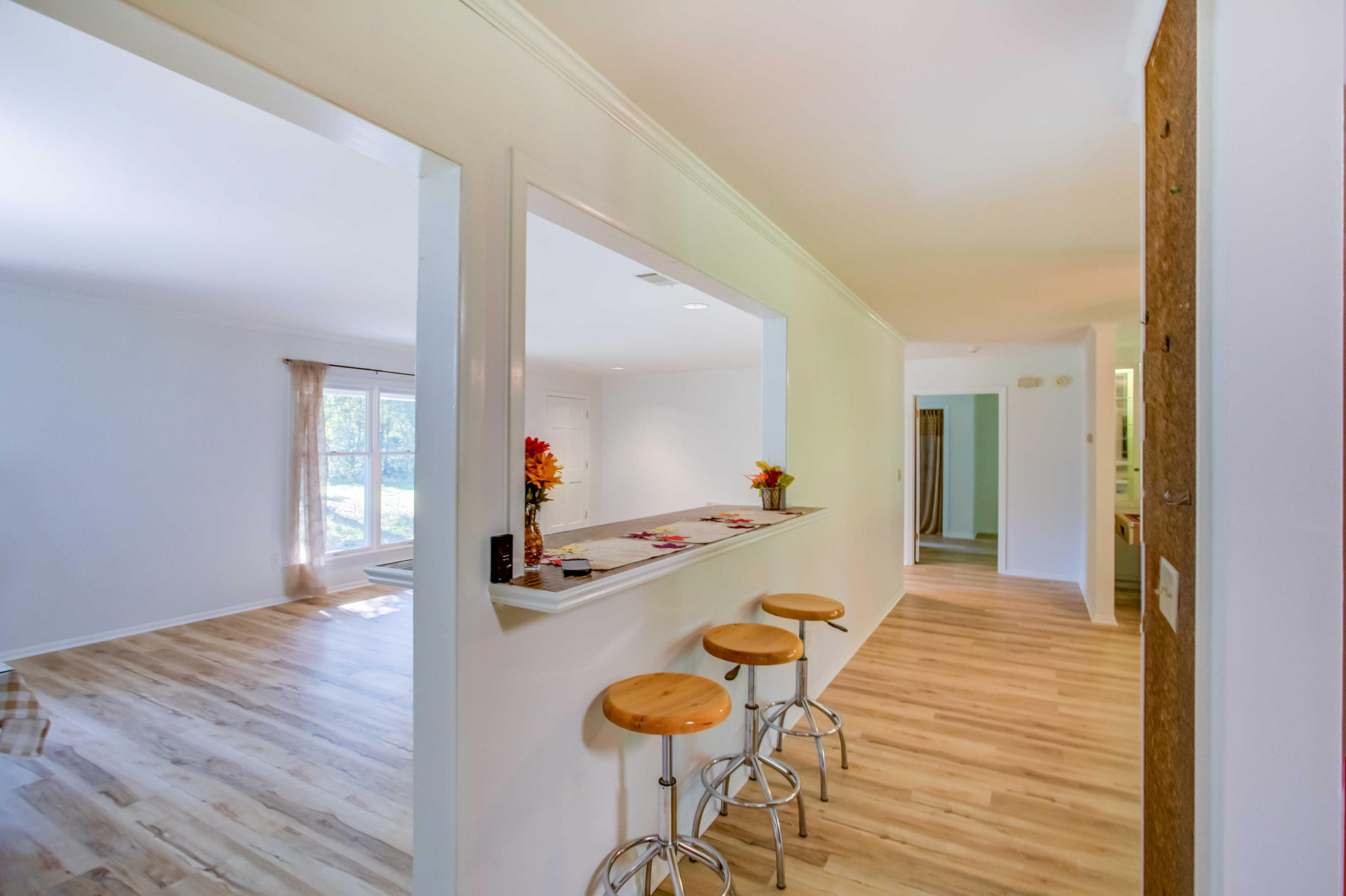 6116 Pine Ridge Lane Crestview, FL 32539 - Photo 19 of 45 a hallway with dining room and wooden floor