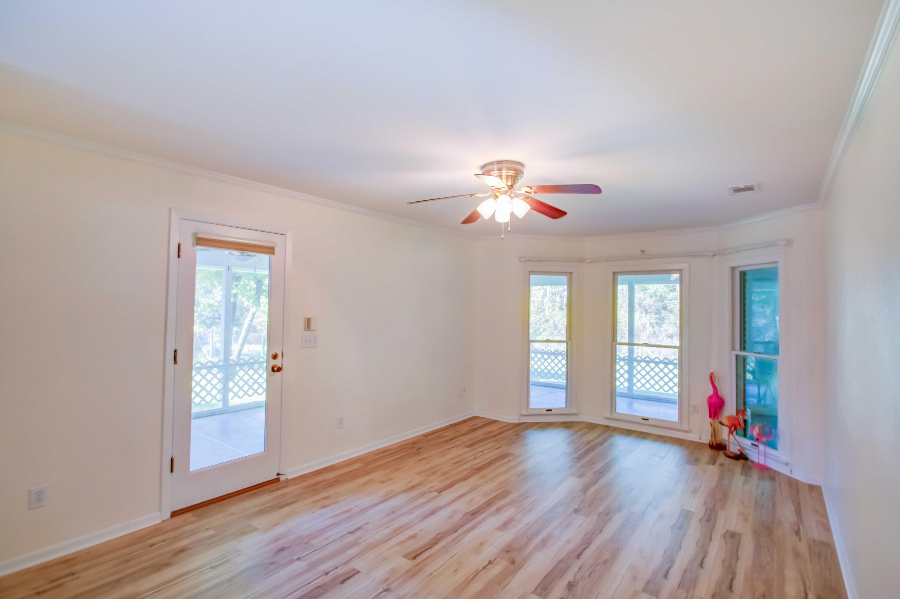 6116 Pine Ridge Lane Crestview, FL 32539 - Photo 21 of 45 a view of an empty room with window and wooden floor