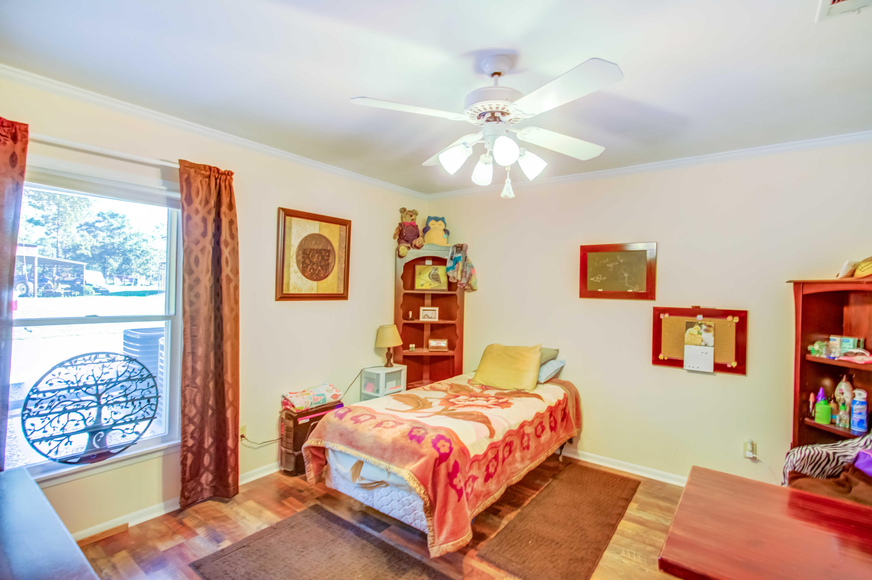 6116 Pine Ridge Lane Crestview, FL 32539 - Photo 27 of 45 a bedroom with a bed bookshelf and a window