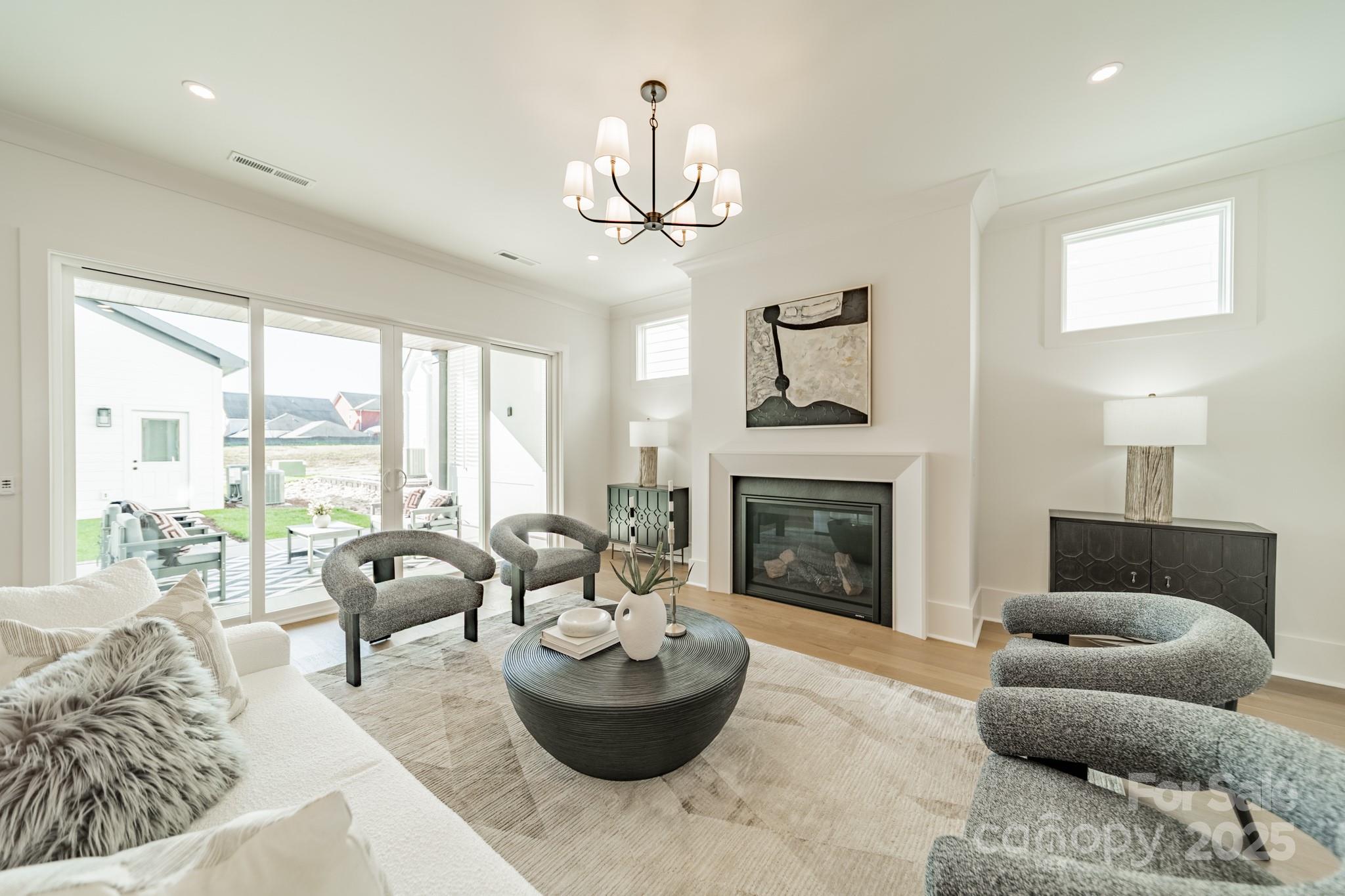 19032 Newburg Hill Road, Unit 23 Davidson, NC 28036 - Photo 12 of 39 a living room with furniture and a fireplace